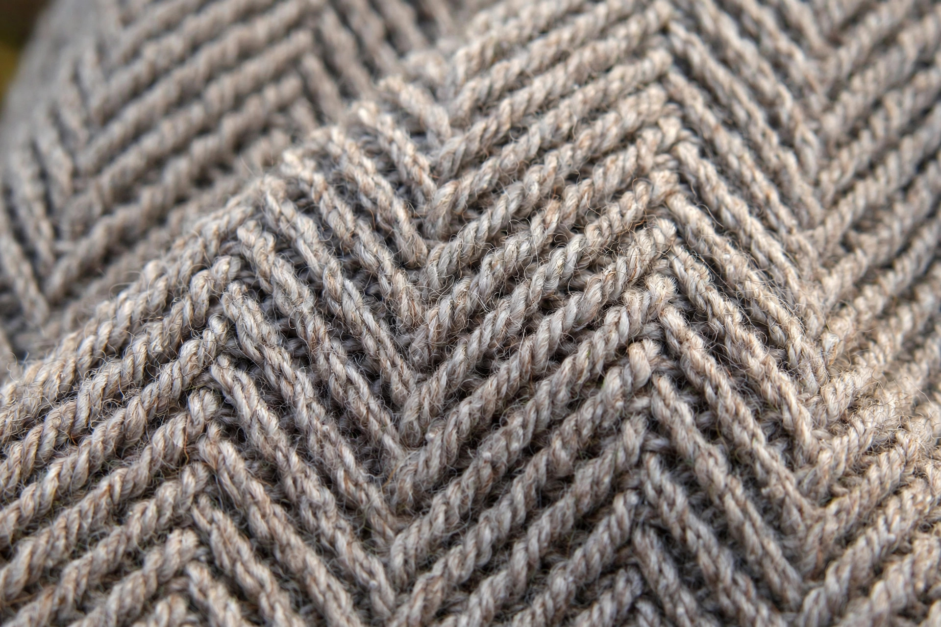 Close-up of herringbone half double crochet stitch texture in heather grey yarn showing diagonal woven pattern