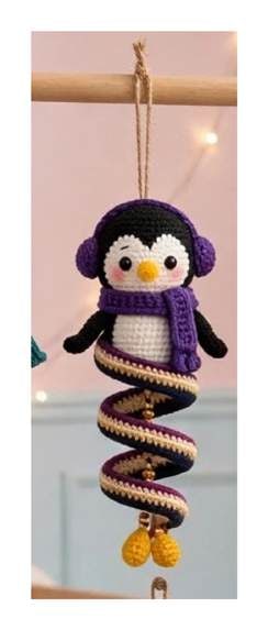 Finished Penguin spiral ornament — charcoal head with cream face patch, purple earmuffs and scarf, orange beak, and dark spiral body