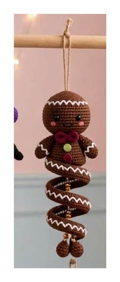 Finished Gingerbread spiral ornament — gingerbread brown spiral with white icing trim, berry bow, and embroidered buttons