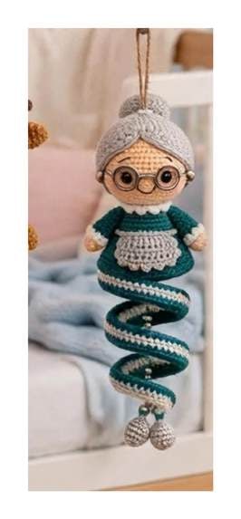 Finished Winter Girl spiral ornament — skin beige face with grey hair bun and embroidered glasses, teal spiral, and cream apron